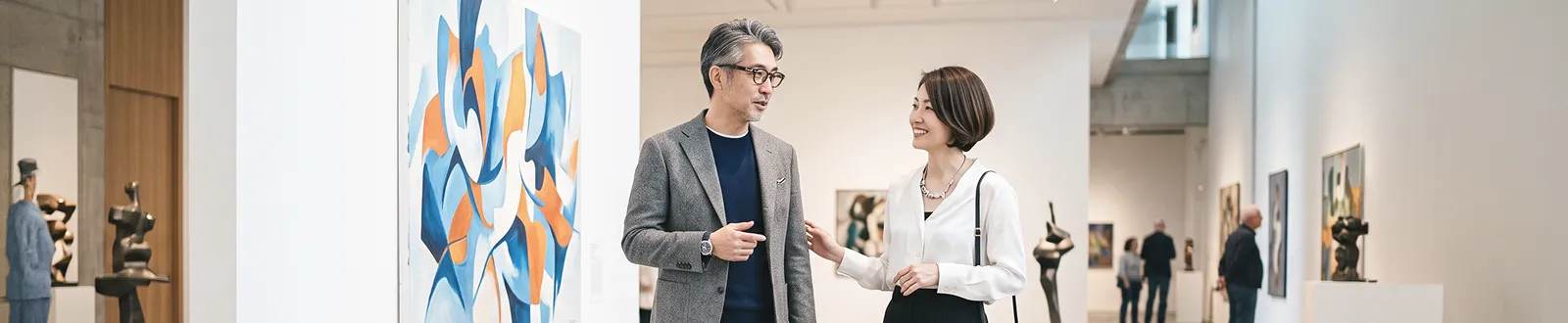 美術館で会話を楽しむ男女の写真